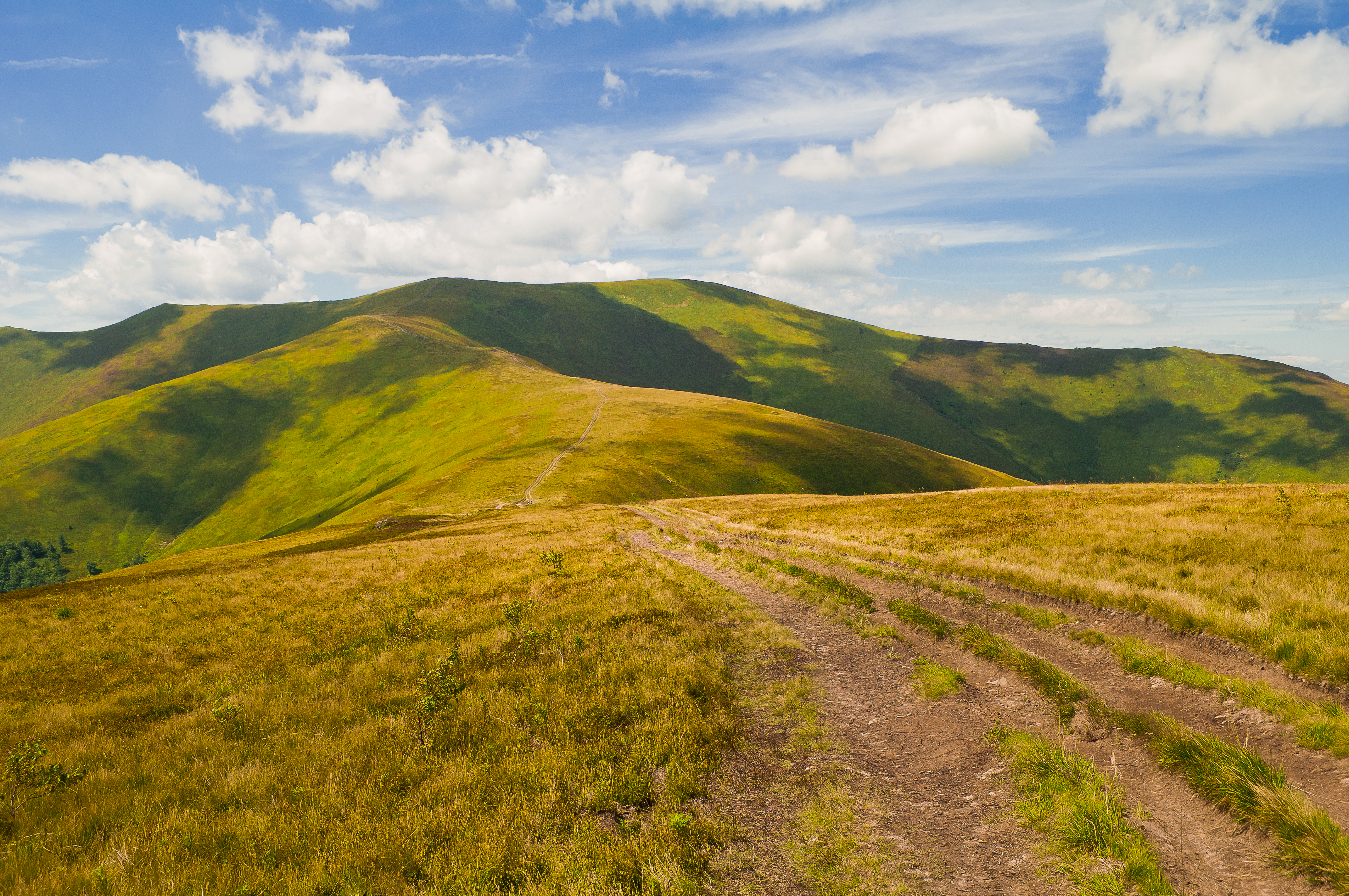 Summer mountain landscape with road and shadow of clouds LandTank